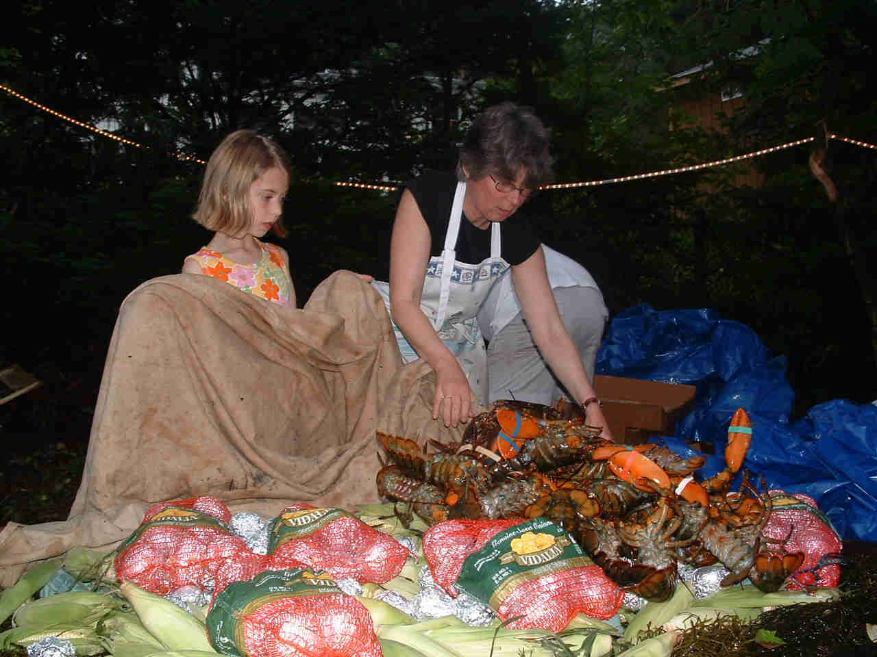 adding lobsters to the bake